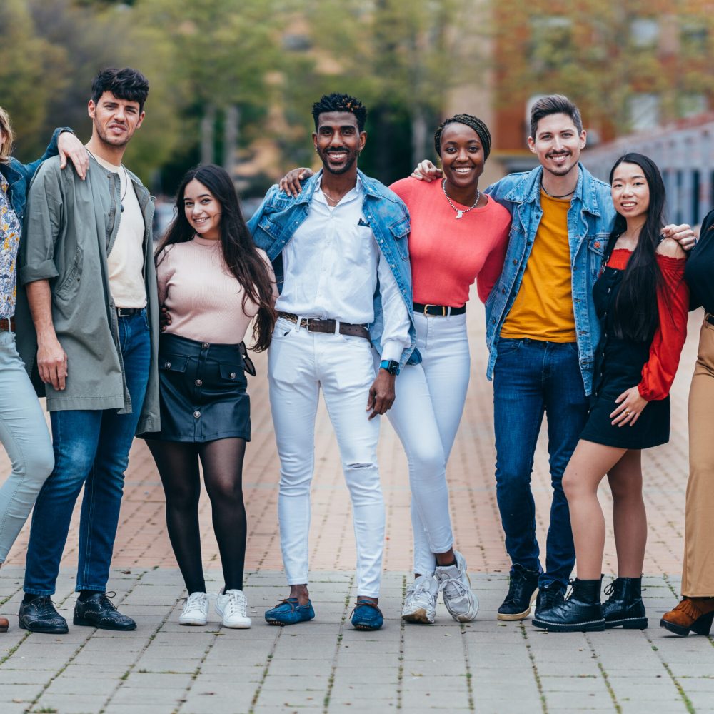 full shot of a multiethnic portrait of 8 people in the street