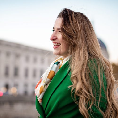 young-woman-wearing-green-looking-away-and-smiling-2025-01-09-06-17-20-utc